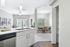 Bright open-plan apartment featuring a sleek kitchen island, cozy dining area, and a stylish living space with modern decor.