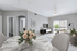 Chic modern living room with gray tones, stylish marble dining table, and bright natural light from large windows.