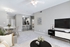 Elegant open-concept living space with modern kitchen, cozy dining area, and stylish lounge, perfect for entertaining.
