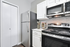Modern kitchen with sleek stainless steel appliances, stylish backsplash, and ample cabinet space.