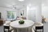 Bright, modern living room with stylish decor, cozy seating, and a view of the lush outdoor area through sliding glass doors.