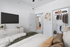 Chic bedroom with stylish decor, featuring a modern entertainment setup, cozy bedding, and an organized walk-in closet.
