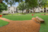 Inviting apartment community surrounded by lush greenery, featuring a dog park and paved walkways for leisurely strolls.