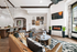 Luxurious clubhouse with modern decor featuring a cozy fireplace, chic seating area, and stylish open-concept kitchen and dining space.