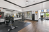 Modern fitness center featuring state-of-the-art exercise equipment, spacious workout areas, and bright natural lighting.