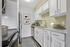 Modern kitchen featuring sleek white cabinetry, stainless steel appliances, and elegant decor accents, perfect for culinary creativity.