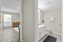 Bright and modern apartment interior featuring a cozy bedroom with natural light and an adjacent sleek bathroom with elegant fixtures.