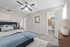 Chic bedroom with modern ceiling fan, stylish decor, and spacious walk-in closet.