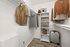 Spacious walk-in closet with organized shelving, hanging clothes, and ample storage space in a modern apartment.
