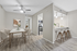 Chic apartment dining area with a modern marble table, elegant chairs, and a stylish open-plan kitchen featuring a breakfast bar and contemporary lighting.