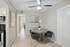 Chic dining area with modern round table, plush chairs, and elegant lighting, adjacent to a stylish kitchen, showcasing contemporary apartment living.