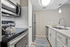 Modern kitchen with sleek stainless steel appliances, elegant white cabinets, and a stylish subway tile backsplash.