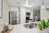 Modern kitchen with sleek stainless steel appliances, elegant white cabinetry, and contemporary lighting, providing a sophisticated and inviting ambiance.