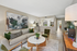 Contemporary living room with elegant decor, cozy seating, and an open layout leading to a sleek kitchen.