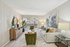 Bright and inviting living room with modern decor, featuring a comfortable sofa, stylish artwork, and large windows with natural light.