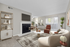 Contemporary living room with elegant furniture, stylish fireplace, and abundant natural light from large sliding doors.