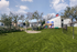 Inviting outdoor dog park with vibrant equipment set on lush green grass, perfect for family fun and relaxation.