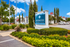Inviting exterior view of Lexington Apartment Homes with lush landscaping and a clear blue sky.