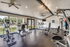 Modern fitness center with state-of-the-art gym equipment, including treadmills and exercise bikes, in a bright, spacious setting.