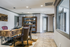 Elegant and modern leasing office space featuring a rustic wooden desk, refined leather chairs, and a stylish shelving unit, perfect for a productive home workspace.