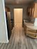 Chic apartment kitchen with modern appliances, sleek wooden cabinets, and elegant flooring.