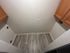 Cozy laundry area with elegant wood flooring and spacious cabinetry, perfect for apartment living.