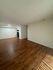 Spacious apartment interior with elegant wood flooring, ample natural light, and modern design ideal for comfortable living.
