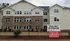 Charming three-story residential building with modern architecture and welcoming ambiance, highlighted by a beautifully crafted brick exterior and spacious windows.