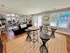 Inviting community room with elegant seating, stylish decor, and abundant natural light, offering a relaxing view of the outdoor pool area.