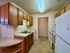 Charming kitchen with warm wooden cabinetry, sleek countertops, and modern appliances creating a cozy and functional space.