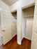 Spacious dual closets with shelving, featuring elegant white doors and warm wood flooring.