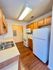 Inviting kitchen with warm wood cabinets, sleek countertops, and modern appliances, perfect for culinary creativity.
