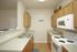 kitchen with stover, microwave, and sink