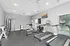 Modern fitness center with state-of-the-art treadmills, exercise bikes, and a weight training area, offering a bright and inviting workout space.