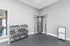 Modern fitness room with sleek dumbbell rack and versatile workout machine, perfect for home gym enthusiasts.