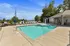 Inviting outdoor swimming pool area with comfortable lounge chairs, a unique water feature, and scenic views, perfect for relaxing and soaking up the sun.
