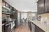 Sleek kitchen with modern stainless steel appliances, granite countertops, and bright dining area.