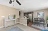 Modern open-concept kitchen and dining area with sleek stainless steel appliances, warm wood flooring, and stylish decor.