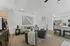 Chic open concept living room with elegant furnishings, modern kitchen, and stylish decor.