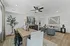 Chic open-concept living and dining area featuring modern furniture, sophisticated decor, and warm natural accents.