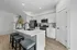 Contemporary kitchen with sleek white cabinetry, modern appliances, and a chic island bar perfect for entertaining.