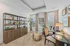 Charming home office with elegant shelving, cozy seating, and natural light, perfect for productivity and inspiration.