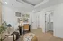 Cozy and inviting apartment office nook with butterfly-themed wall art, elegant desk space, and plush seating.