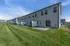 Modern townhouse row with pristine green lawns and private patios, perfect for outdoor enjoyment.