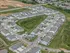 Aerial view of a vibrant modern neighborhood with stylish townhouses, lush green spaces, and a community pool on pristine streets.