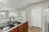 Modern kitchen featuring elegant countertops, stainless steel sink, and ambient lighting, perfect for culinary creativity.