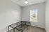 Bright and airy bedroom with a window view, modern ceiling fan, and carpet flooring, primed for customization and comfort.