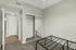 Bright bedroom featuring plush carpet, mirrored closet doors, and modern ceiling fan, perfect for cozy living.