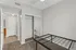 Bright and cozy bedroom showcasing new carpet, mirrored closet doors, and a ceiling fan for comfort.