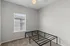 Bright and airy bedroom featuring a metal bed frame, soft carpet flooring, and a ceiling fan for comfort.